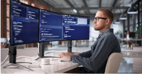 Developer working across multiple screens